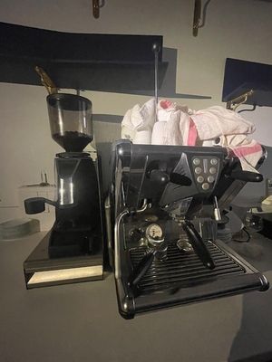 a black coffee machine sitting on a counter in a kitchen