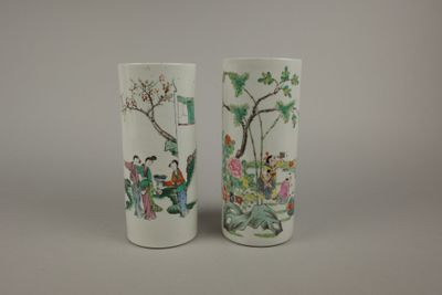 two vases with asian designs on them on a table