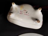 a white plate that has a cow shaped plate on it