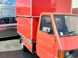 a red truck that is parked in a parking lot