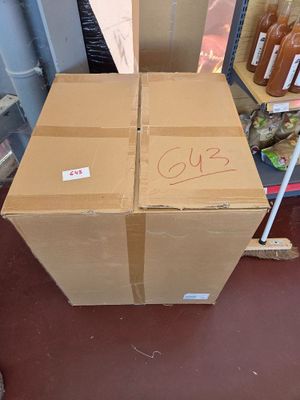 a cardboard box sitting on the floor next to some bottles