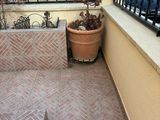 a small patio with a potted plant on it