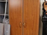 a wooden cabinet with a guitar on top of it