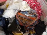 a pile of clothes sitting on top of a bed