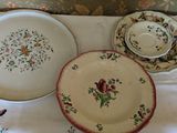 two plates and a bowl sitting on a table