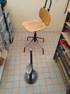 une chaise posée sur un tabouret dans un coin de la pièce