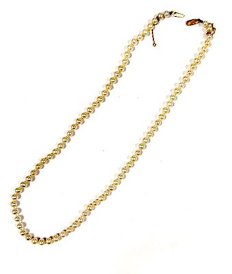a close up of a necklace with pearls on a white background