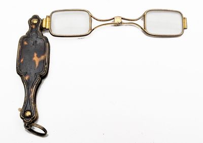 a pair of glasses and a pair of scissors on a white surface