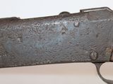 an old gun with a wooden barrel and a metal handle