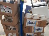 a cart full of boxes and bags of items in a warehouse