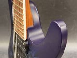 purple electric guitar sitting on top of a metal surface