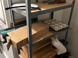 une étagère sur laquelle sont posées de nombreuses boîtes et casseroles