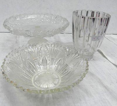 a glass bowl and a glass candle holder on a table