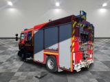 a red fire truck that is parked in a room