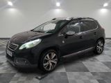 la voiture noire est garée sur un sol en damier dans le garage