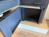 a metal cabinet with a door open on a hard wood floor