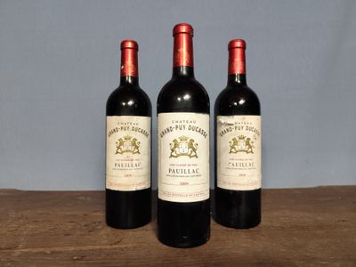 three bottles of wine sitting on top of a wooden table