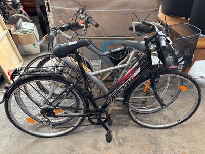 two bikes that are parked next to each other