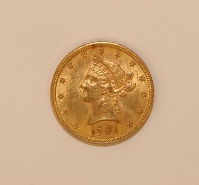 a close up of a gold coin with a woman ' s head on it