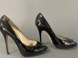black high heeled shoes with a bow on the toe