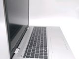 a silver laptop with a black keyboard on a white surface