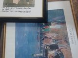 three framed pictures on a table on the floor