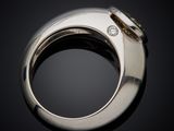 a close up of a silver ring with a diamond in the middle