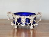 a blue glass bowl sitting on a wooden table