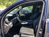 the interior of a car with the door open and the driver ' s seat down