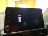 a cell phone in the center of a car ' s dashboard