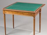 a small table with a green top and wooden legs