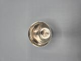 a close up of a silver cup on a gray surface