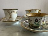 two cups and saucers sitting on a table