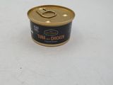 a can of tuna and chicken sitting on a table