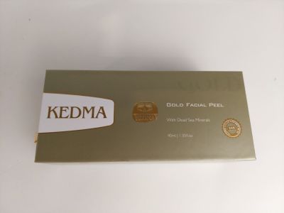 a close up of a box of gold facial peels on a white surface