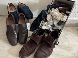 two pairs of shoes sitting in a suitcase on the floor