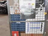 a metal cart with many boxes on it in a warehouse