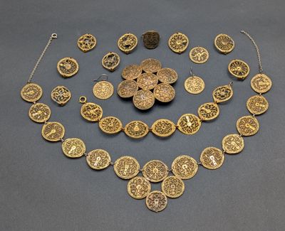 a gold plated necklace and bracelet set with circular medallions