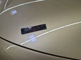 a sticker that says caution on the hood of a car