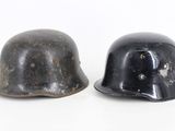 pair of black helmets with holes on them sitting next to each other