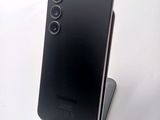 a black phone that is sitting on top of a stand