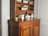 a china cabinet with china on it in the corner of a room