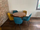 a table and chairs in a room with a brick wall
