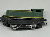 a green and yellow train engine on a white surface