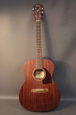 a close up of an acoustic guitar on a gray background