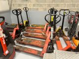 a lot of forklifts that are lined up in a room