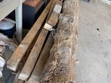 a pile of wood sitting on top of a wooden bench
