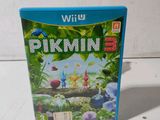 the wii game pikmin is sitting on a white surface