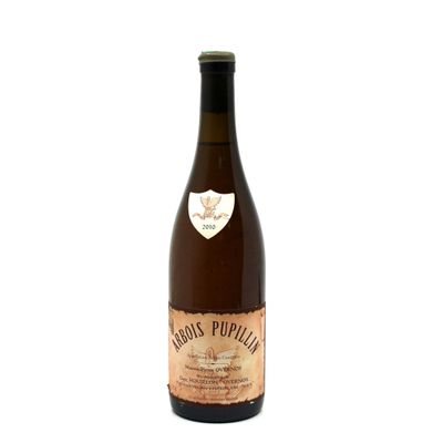 the bottle of wine is sitting on a white surface