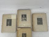 three old books sitting on top of a white table next to each other